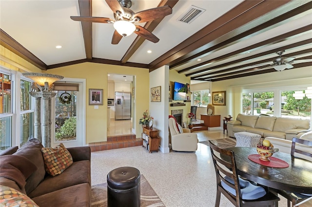 living room with ceiling fan and vaulted ceiling with beams