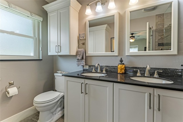 bathroom with toilet, vanity, and ceiling fan