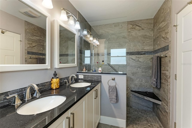 bathroom featuring vanity and a tile shower