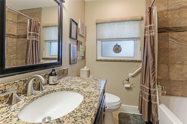 full bathroom with toilet, vanity, a healthy amount of sunlight, and shower / bathtub combination with curtain