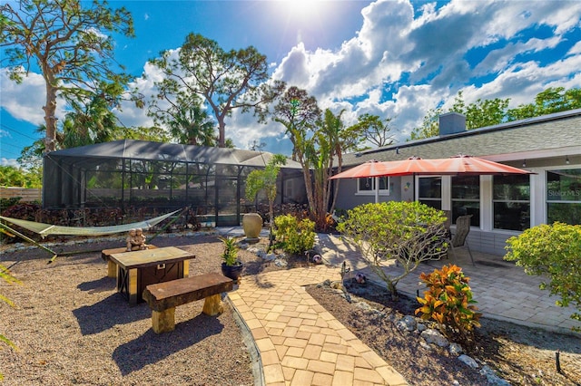 view of yard with a patio and glass enclosure