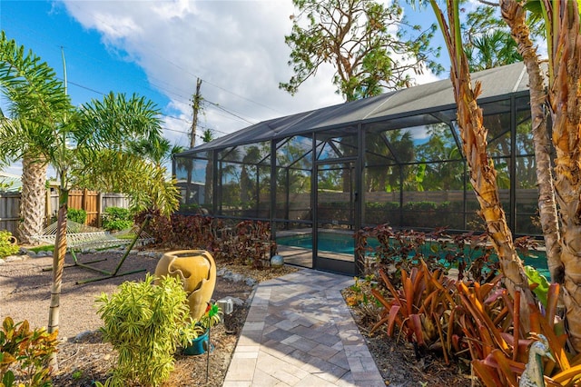 view of patio / terrace with a fenced in pool and glass enclosure