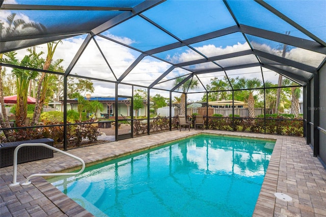 view of swimming pool with a lanai and a patio