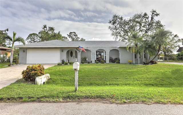 single story home with a garage and a front lawn