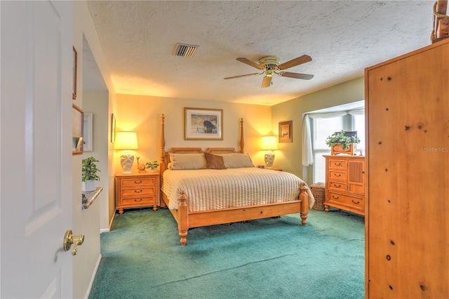 bedroom featuring ceiling fan, a textured ceiling, and carpet floors