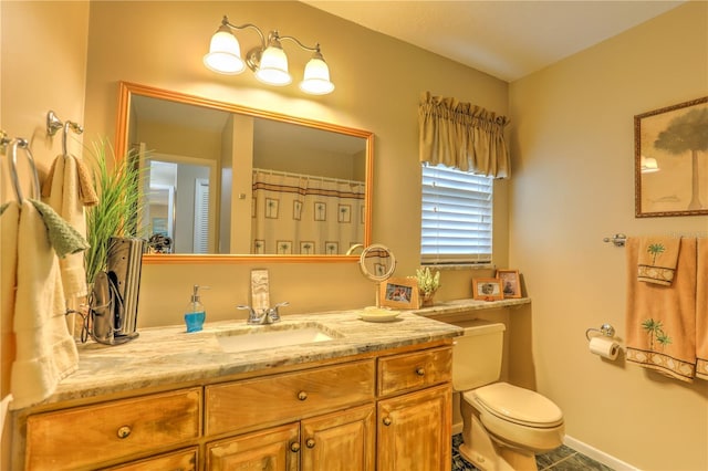 bathroom with tile patterned flooring, vanity, and toilet