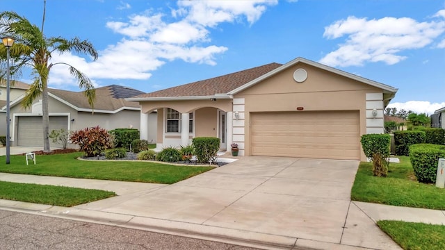 ranch-style house featuring a garage and a front yard