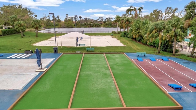 surrounding community featuring a water view and a lawn