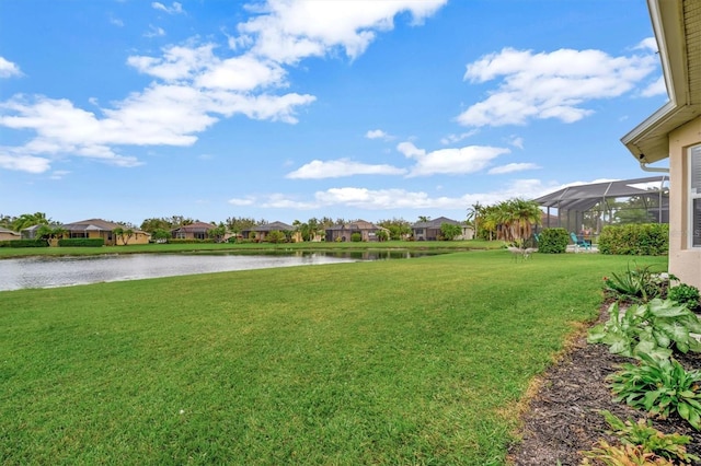 view of yard featuring a water view and a lanai