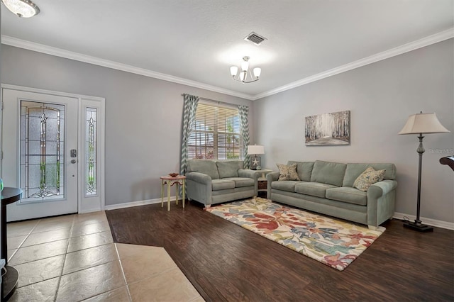 living room with an inviting chandelier, ornamental molding, and dark hardwood / wood-style floors