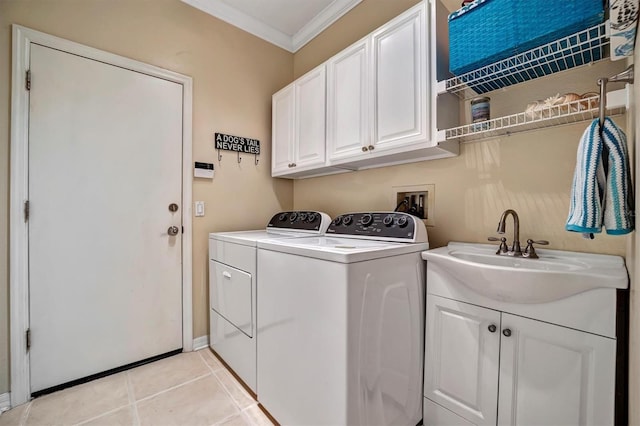 laundry room with light tile patterned flooring, crown molding, cabinets, sink, and washing machine and dryer