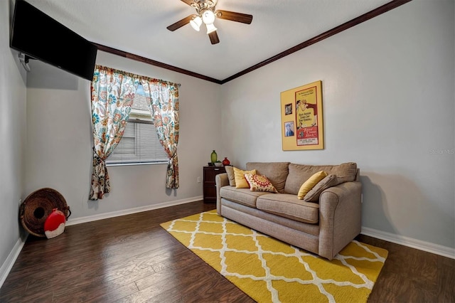 living room with dark wood-type flooring, ceiling fan, and crown molding