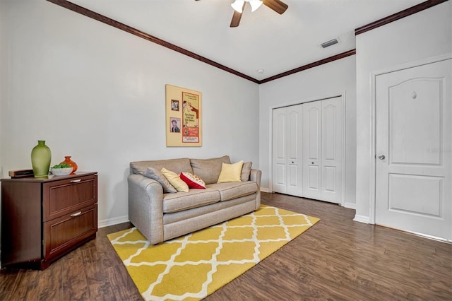 living room featuring dark wood-type flooring, ceiling fan, and crown molding