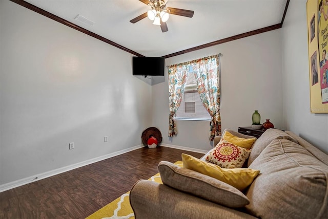 living room featuring dark wood-type flooring, ornamental molding, and ceiling fan