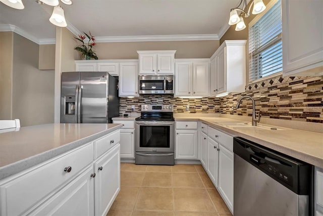 kitchen with stainless steel appliances, white cabinetry, sink, and tasteful backsplash