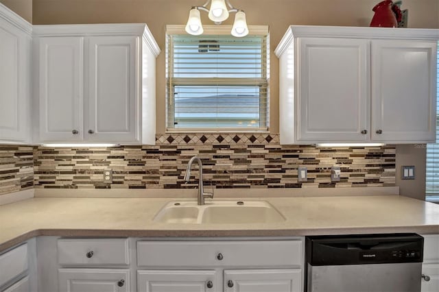 kitchen with stainless steel dishwasher, white cabinets, and sink