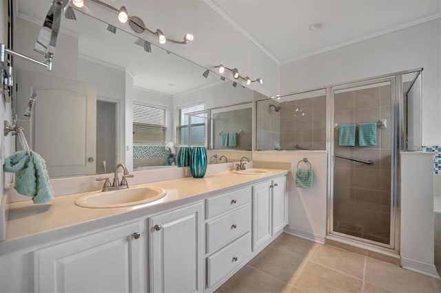 bathroom featuring vanity, tile patterned floors, crown molding, and a shower with shower door