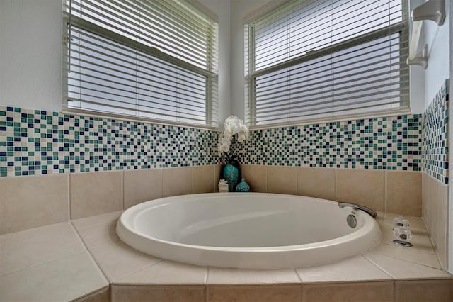 bathroom featuring tiled tub