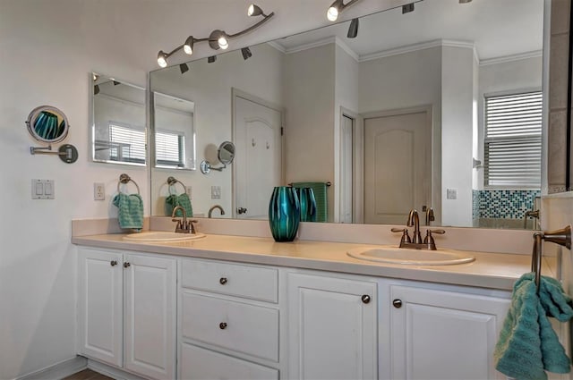 bathroom with vanity, a healthy amount of sunlight, and crown molding