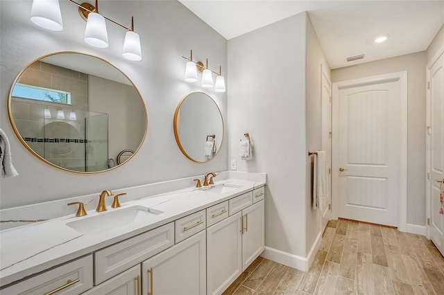 bathroom featuring wood-type flooring, vanity, and a shower