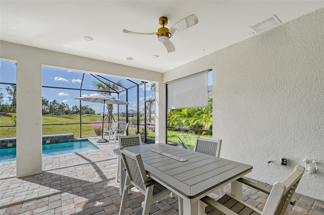 view of patio / terrace with ceiling fan and glass enclosure