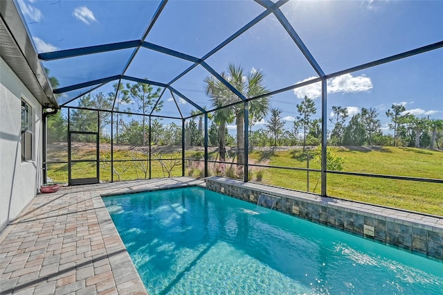 view of swimming pool featuring pool water feature, a lanai, a patio area, and a lawn