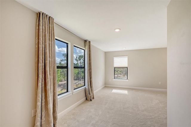 unfurnished room featuring light colored carpet