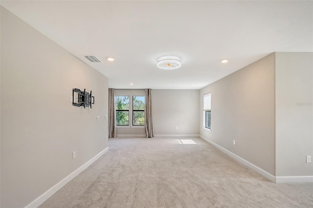 spare room featuring light colored carpet