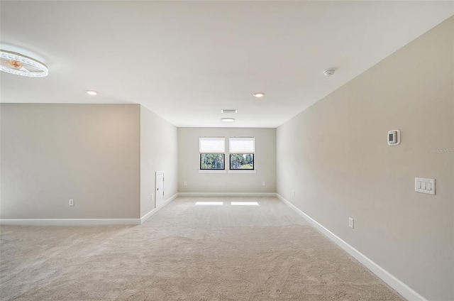 spare room with light colored carpet