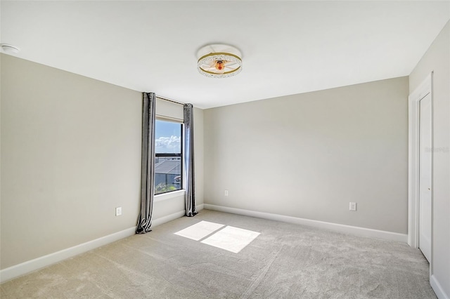 spare room featuring light colored carpet