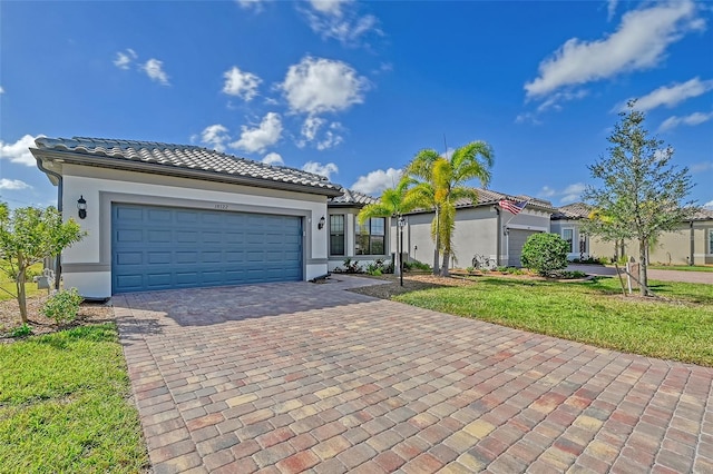 view of front of property featuring a garage and a front yard