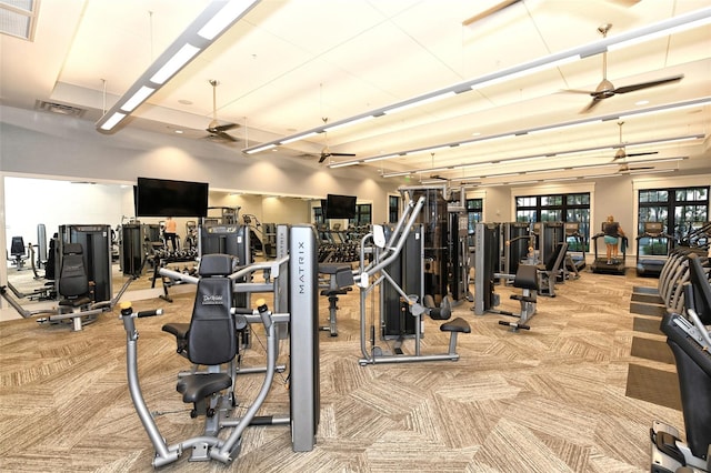 workout area with light colored carpet and ceiling fan