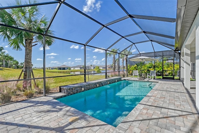 view of pool featuring a lanai, a patio, pool water feature, and a lawn