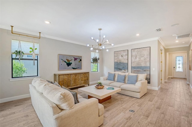 living room with an inviting chandelier, ornamental molding, and light hardwood / wood-style floors