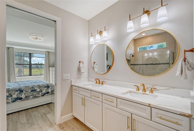 bathroom featuring vanity, wood-type flooring, and walk in shower