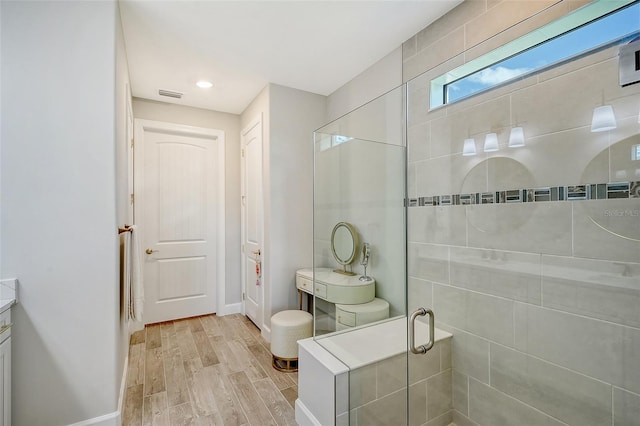 bathroom with vanity, hardwood / wood-style floors, and a shower with shower door