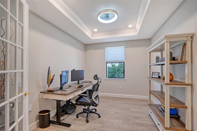 home office featuring ornamental molding, a raised ceiling, and light wood-type flooring