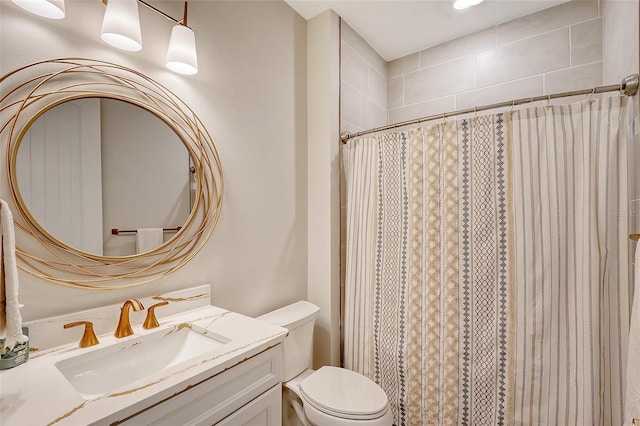 bathroom featuring vanity, walk in shower, and toilet