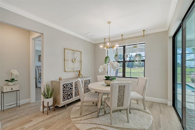 dining space with ornamental molding, a chandelier, and light hardwood / wood-style flooring