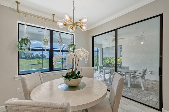 dining space with crown molding, a chandelier, and light hardwood / wood-style floors