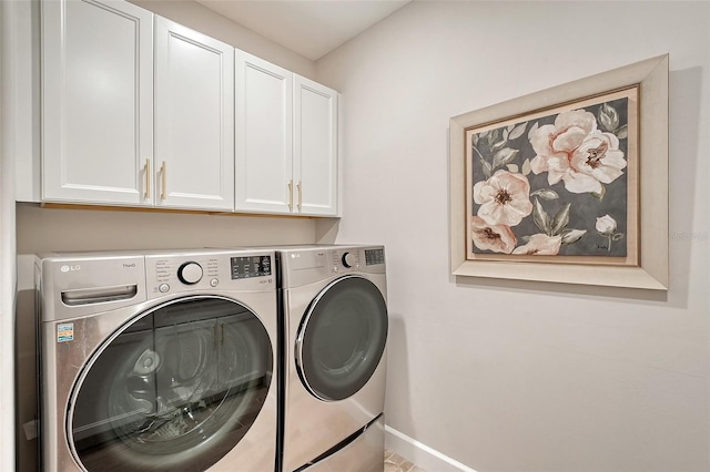 washroom with cabinets and washing machine and dryer