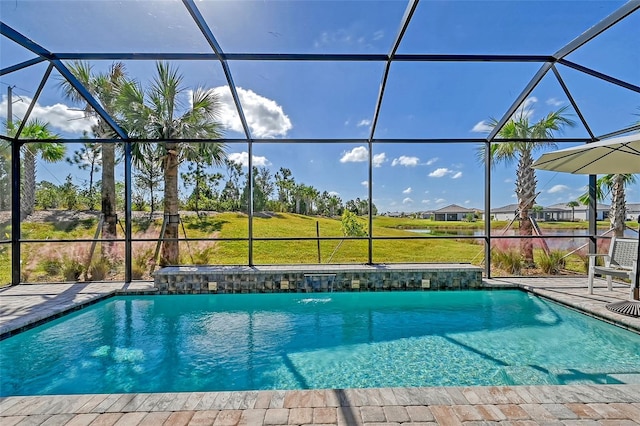 view of swimming pool with a yard, a lanai, and a patio