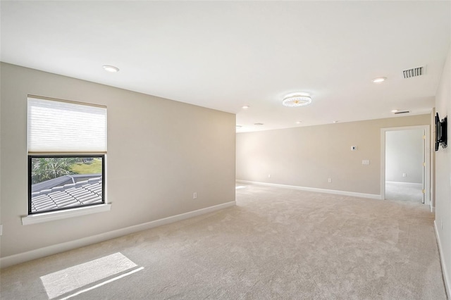 empty room featuring light colored carpet