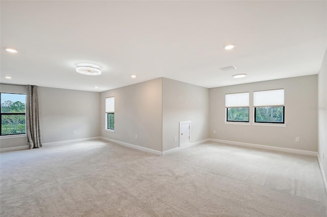 carpeted empty room with a wealth of natural light