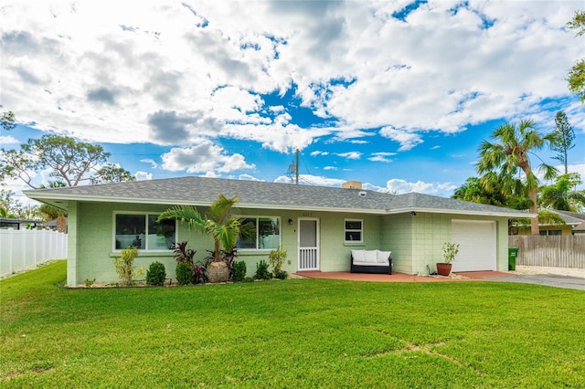 ranch-style home with a garage and a front lawn