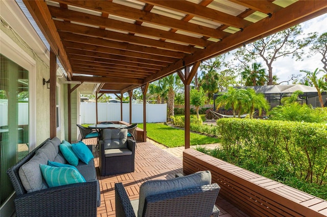 wooden deck featuring an outdoor hangout area and a lawn