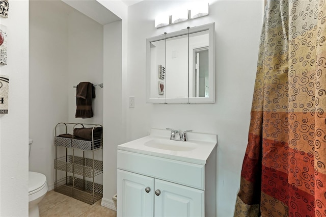 bathroom with vanity, tile patterned floors, and toilet