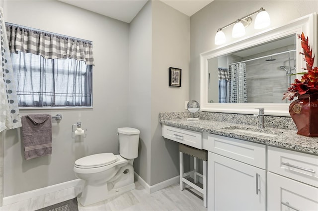 bathroom featuring a shower with shower curtain, toilet, and vanity