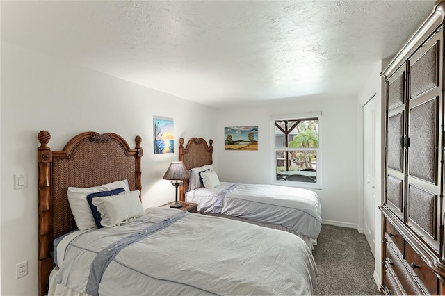 carpeted bedroom with a textured ceiling and a closet