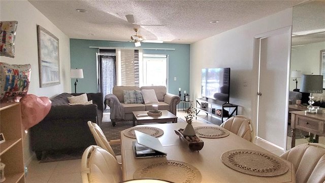 dining space featuring a textured ceiling and ceiling fan